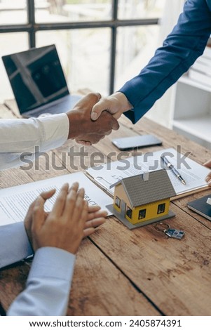 A real estate agent shakes hands with a client after signing the partnership or client contract to enter into a contract. business success concept Close-up pictures
