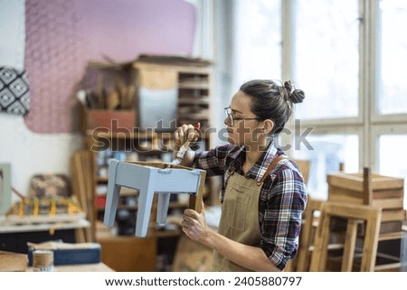 Female carpenter working in her workshop

