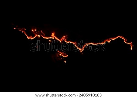 burning paper, glowing edge of paper on a black background Royalty-Free Stock Photo #2405910183