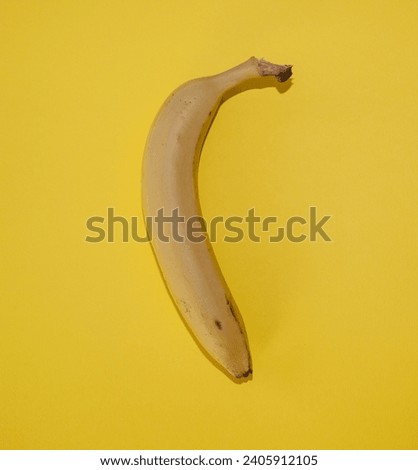 Banana isolated on a yellow background. Flat lay.