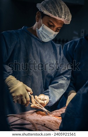 Latin doctor in surgery in operating room. Hospital surgery. Surgery, medicine and people concept.