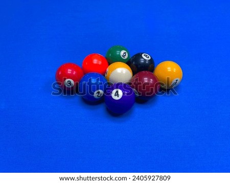 Nine  billiard balls on a blue background Royalty-Free Stock Photo #2405927809