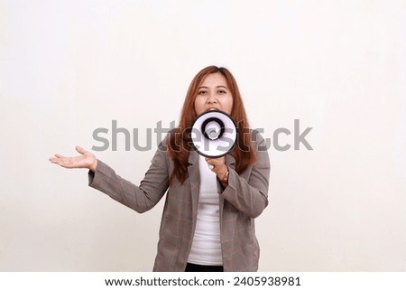 Asian businesswoman holding a megaphone while presenting sideways. Isolated on white