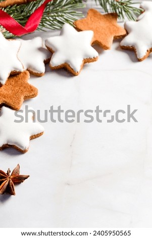Traditional Christmas glazed gingerbread cookies in the shape of a star. Cookies for the holiday. New Year's decor. White background. Copy space