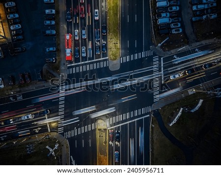 An aerial view at night using a long exposure. Shot over a large highway intersection showing motion blur of the passing vehicles.