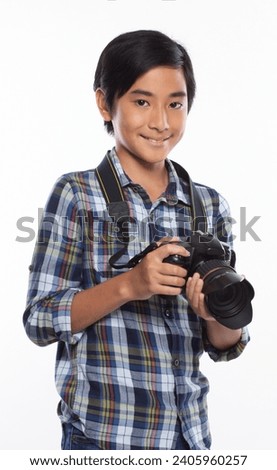 asian boy with camera on white background