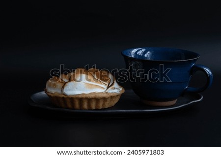 Delicious Lemon meringue pie on black background