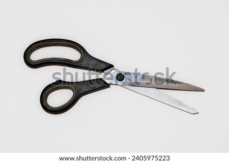 Pair of old used barber scissors with some scratches and dirt isolated on white background. Scissor blades are not open.