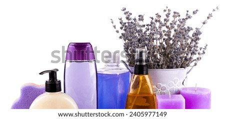 Scented candles, soaps, shampoos and other cosmetics with lavender extract isolated on white background. Wide photo.