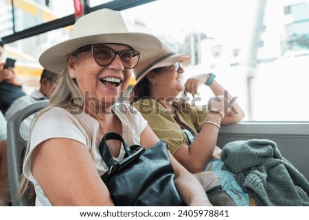 Tourists travel happily on the bus on vacation. Royalty-Free Stock Photo #2405978841