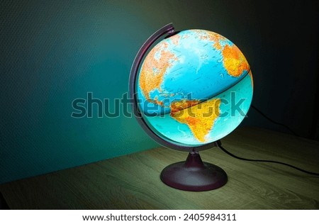 Illuminated globe showing oceans and continents with bright colors Royalty-Free Stock Photo #2405984311