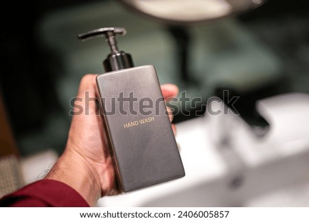 Hand wash soap pumping bottle in luxury design that place on the water faucet sink in the toilet. Interior equipment object photo.