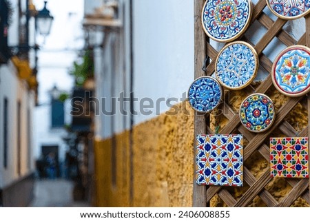 Ceramic tiles hanging on a door in the old neighborhood of Santa Cruz in Seville