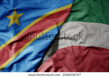 big waving national colorful flag of kuwait and national flag of democratic republic of the congo . macro