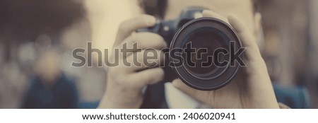 A man in suit taking photo 