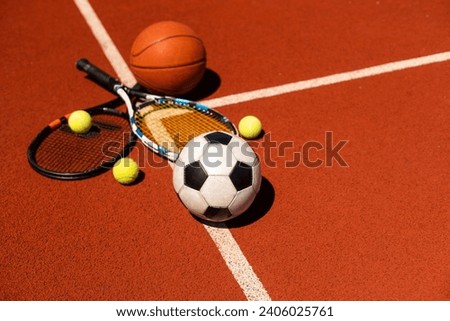 A group of sports equipment on black background including tennis, basketball, and soccer and boxing equipment on a background with copy space