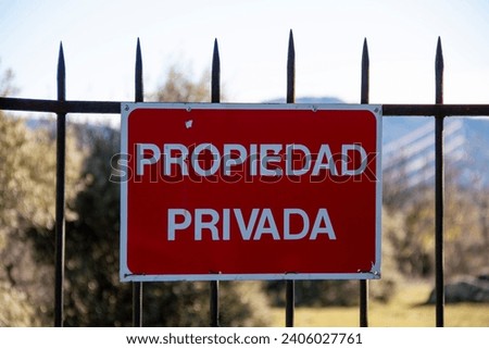 Translation: Private property. Iron bar gate on a dry stone fence that gives access to a privately owned pasture