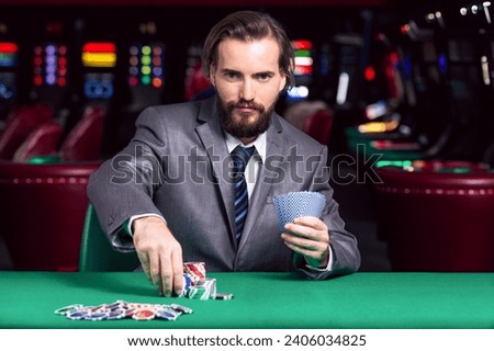 A businessman  in a  suit Places a  Bet at the Casino black jack card game 