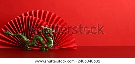Chinese New Year 2024 banner template with dragon and paper cut fan decoration on red background.