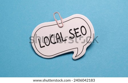 LOCAL SEO on wooden background and modern yellow notepad. Top view composition