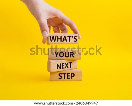 What is your next step symbol. Wooden blocks with words What is your next step. Businessman hand. Beautiful yellow background. Business concept. Copy space. Royalty-Free Stock Photo #2406049947