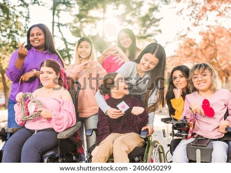 Inspire Inclusion international women's day. Multiethnic group do heart love hand gesture. Disability Royalty-Free Stock Photo #2406050299
