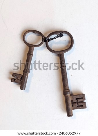 Pair of old rusty antique keys Royalty-Free Stock Photo #2406052977