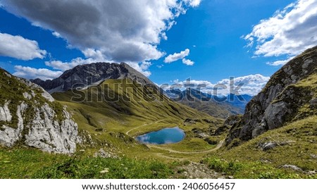 A picturesque mountain alpine lake with clean water on a summer sunny day in Austria, Monzabonasee, Lake Monzabona, Lech, Vorarlberg, Rüfikopf