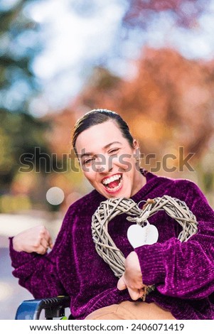 InspireInclusion heart shape, love valentine gesture. Young woman with cerebral palsy disability.  Royalty-Free Stock Photo #2406071419