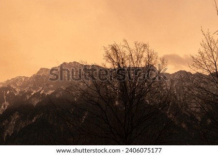Schaan, Liechtenstein, January 17, 2023 Spooky atmospheric condition and a colorful sky in the evening Royalty-Free Stock Photo #2406075177