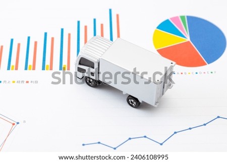 Paper graph and toy truck.
Translation: sales, expenses, profits