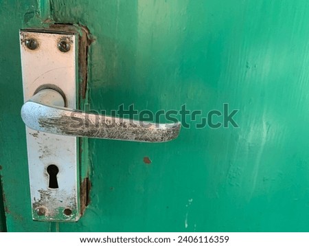 old door handle, Photo of Old Green steel door with hand lock latch with rust
