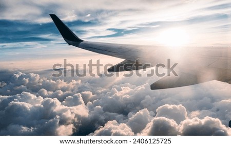 Airplane flight with beautiful daylight and blue sky colors Royalty-Free Stock Photo #2406125725