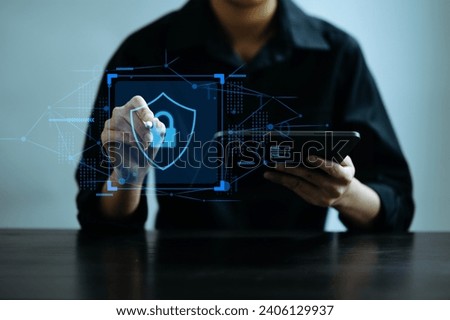 Cybersecurity and privacy concepts to protect data. Lock icon and network security technology. Man protecting personal data on smartphone tablet, virtual screen interfaces. In office
