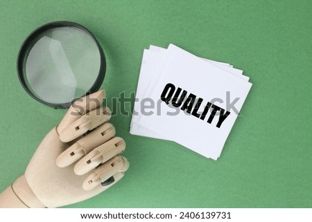magnifying glass and white paper with the word quality. Quality quantity will win. quality concept Royalty-Free Stock Photo #2406139731