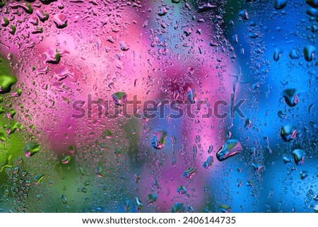 Raindrops on the window. Water drops on glass. Abstract floral background. Texture of drops. Selective soft focus