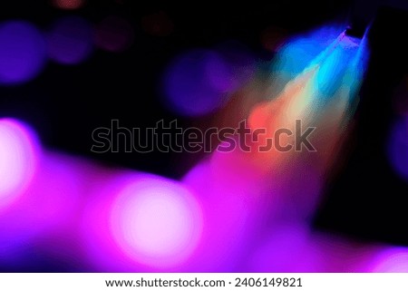Abstract blurred rainbow colour lines and lights on a dark background 
