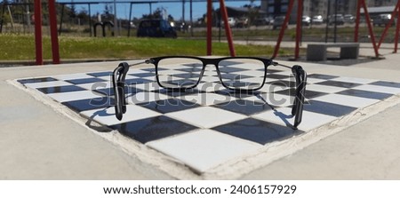 person leaving his glasses on top of the chess board after the game
