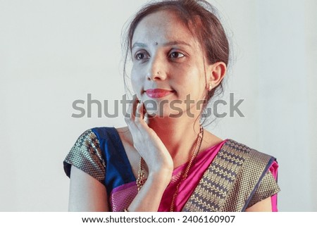 Beautiful Indian woman in sari posing for photo. 