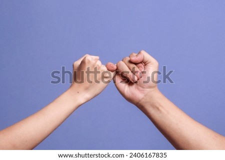 Pinky promise hands gesturing. Concept of reconciliation of friends or lovers. Royalty-Free Stock Photo #2406167835