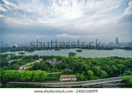 Cloudy sunrise over Daming Lake in the old town of Jinan, Shandong Province in summer Royalty-Free Stock Photo #2406168099