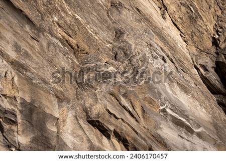Strata of foliated homogeneous metamorphic rock derived from sedimentary rock.They  form from tectonic processes as continental collisions, which cause horizontal pressure, friction and distortion. Royalty-Free Stock Photo #2406170457
