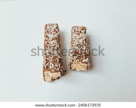 Chocolate wafers studded with coconut. Wafers that have been halved