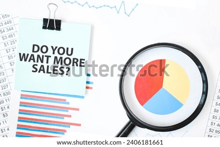Green card on the white notepad and magnifier on the financial documentation. Text DO YOU WANT MORE SALES. Business concept