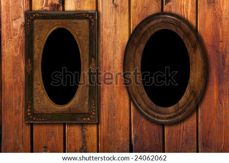 two empty vintage photo-frames on old wooden wall