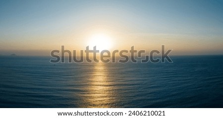 Aerial view of beautiful sea wave and sunrise sky Royalty-Free Stock Photo #2406210021