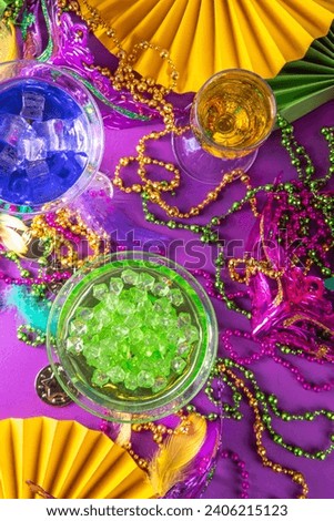 Mardi gras cocktails set. Colorful purple, yellow, green martini champagne wine cocktail glasses for Mardi gras party bar with carnival decor and orleans masquerade masks