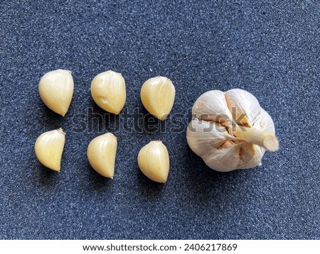 Garlic bulbs on black background, close-up. Food background. Selective focus.
