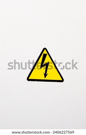 Electricity sign on a metal door with a key