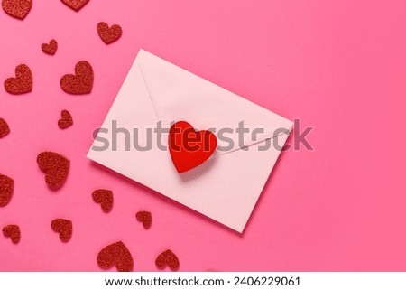 Composition with envelope and red hearts on pink background. Valentine's Day celebration Royalty-Free Stock Photo #2406229061